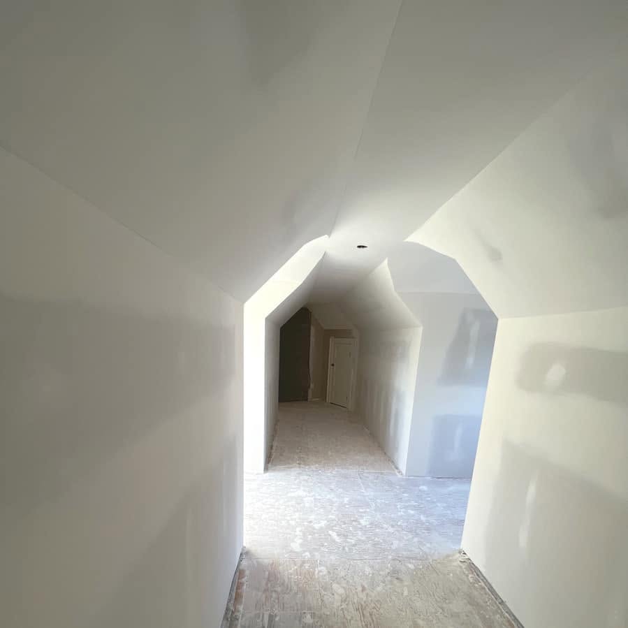 Smooth vaulted hallway ceiling with drywalled arches