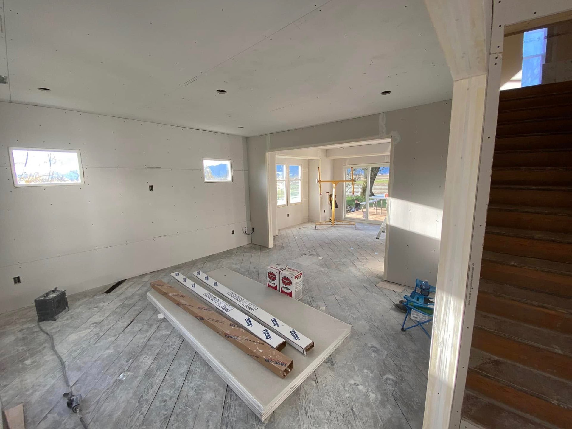 New home interior with freshly hung drywall and mountain view