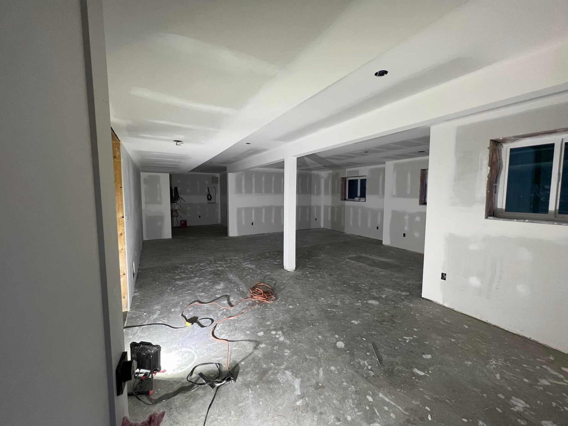 Large open basement with finished drywall and recessed lighting