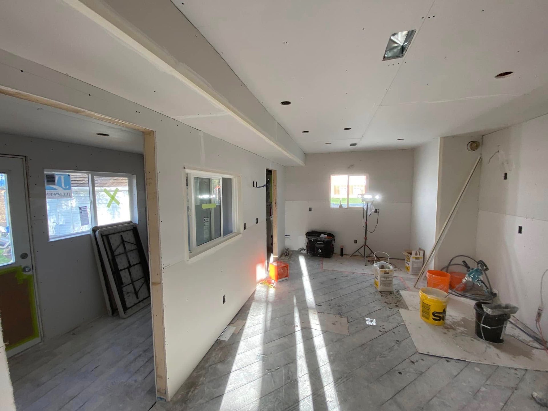Drywall and ceiling work in progress on a home renovation
